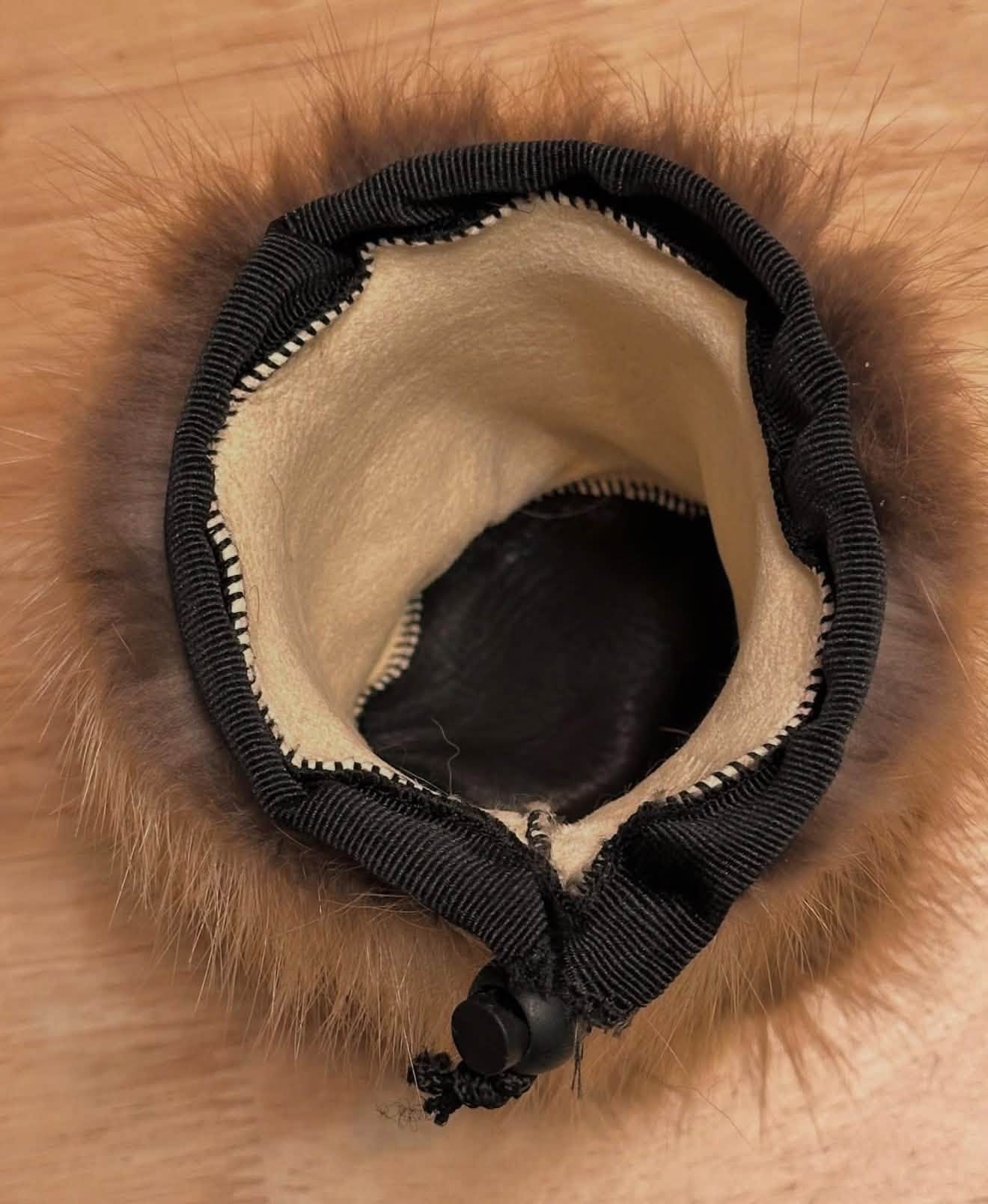 Opening of a coyote fur can cooler with a light lining